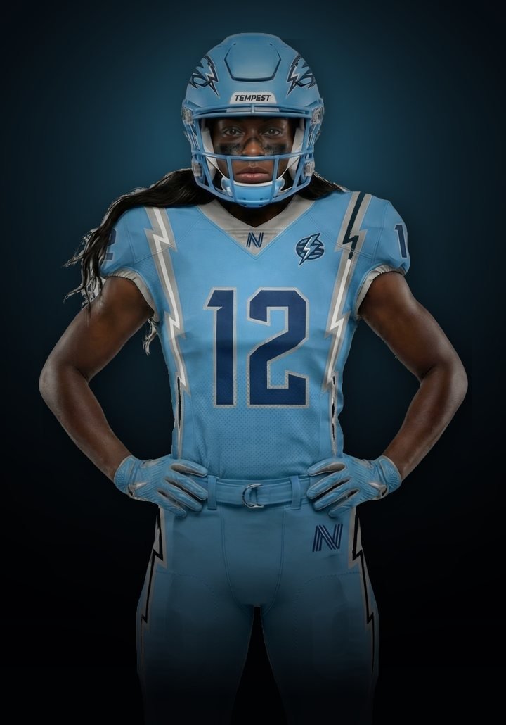 Seattle Tempest athlete in a sky-blue number 12 jersey, hands on hips